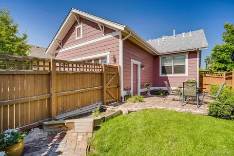 a view of backyard with outdoor seating and plants