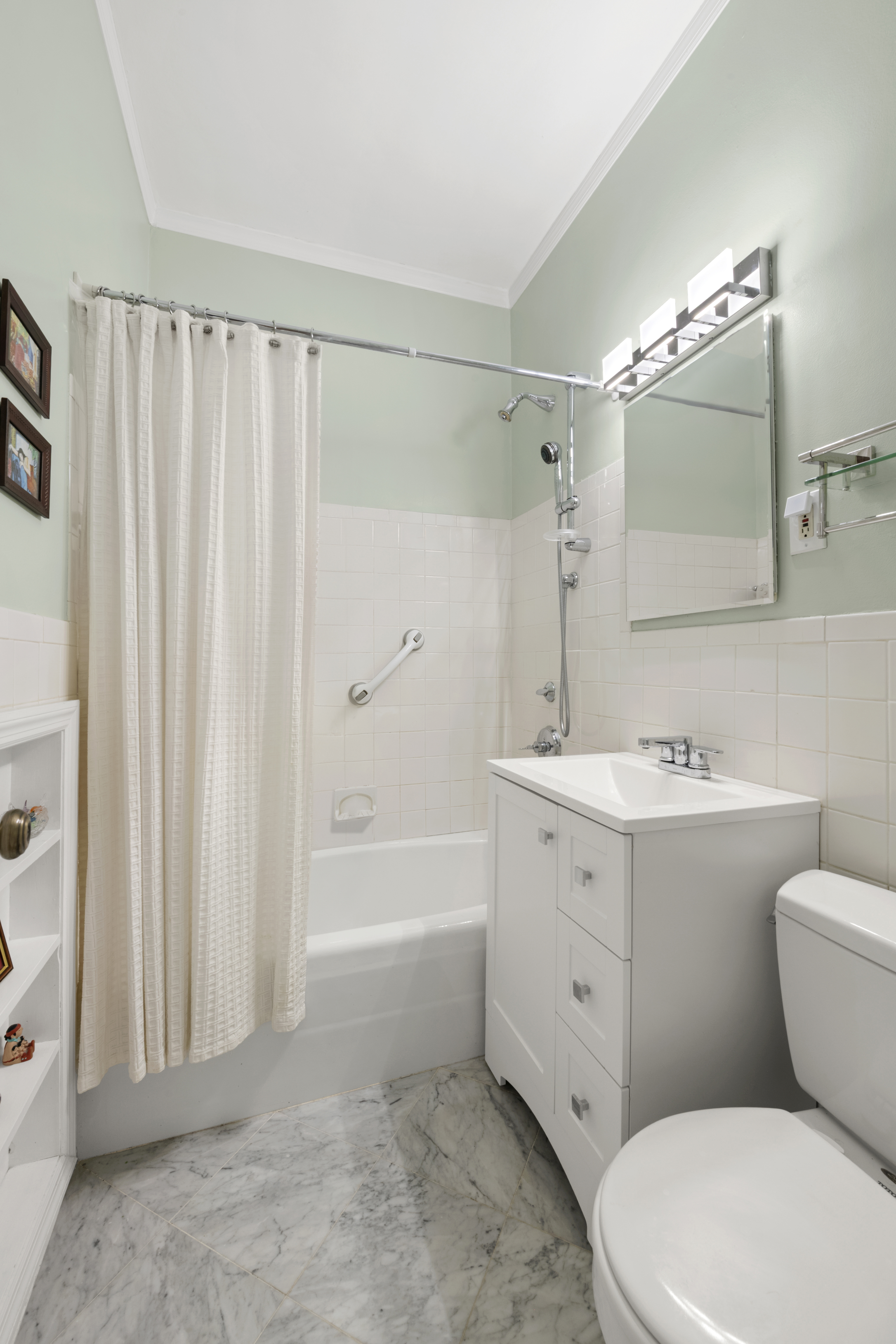 140-142 West End Avenue, Unit 30M Manhattan, NY 10023 - Photo 6 of 11 a bathroom with a sink a mirror a toilet and bathtub