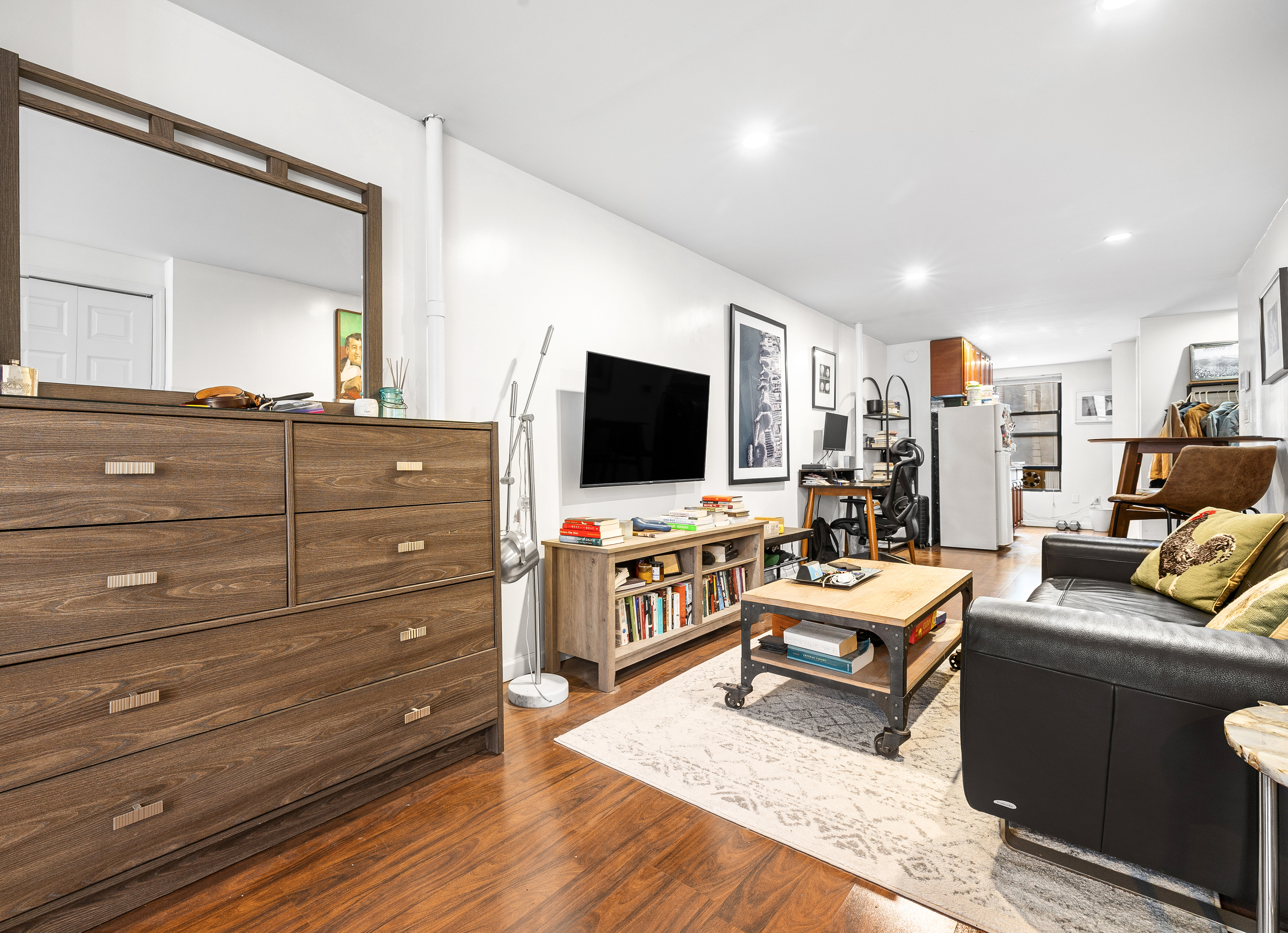 82 East 7th Street, Unit 2 Manhattan, NY 10003 - Photo 8 of 11 a living room with furniture and a flat screen tv