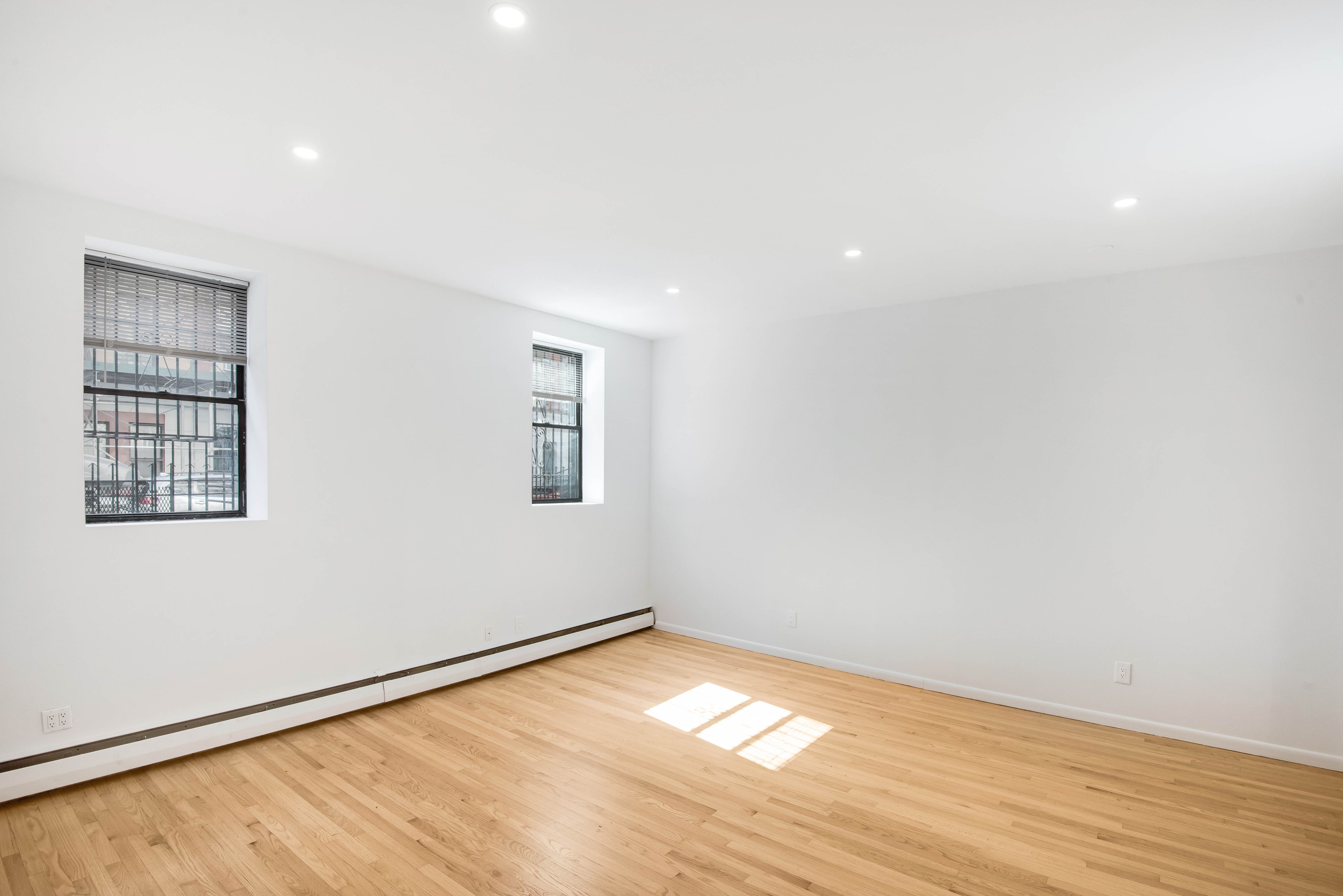 182 East 2nd Street, Unit 1E Manhattan, NY 10009 - Photo 11 of 14 wooden floor in an empty room with a window