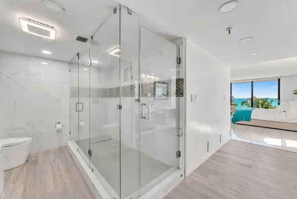 a bathroom with a glass shower door and a sink