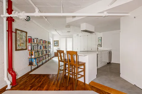 a dining room with furniture and a book shelf