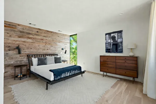 a bedroom with a bed and window