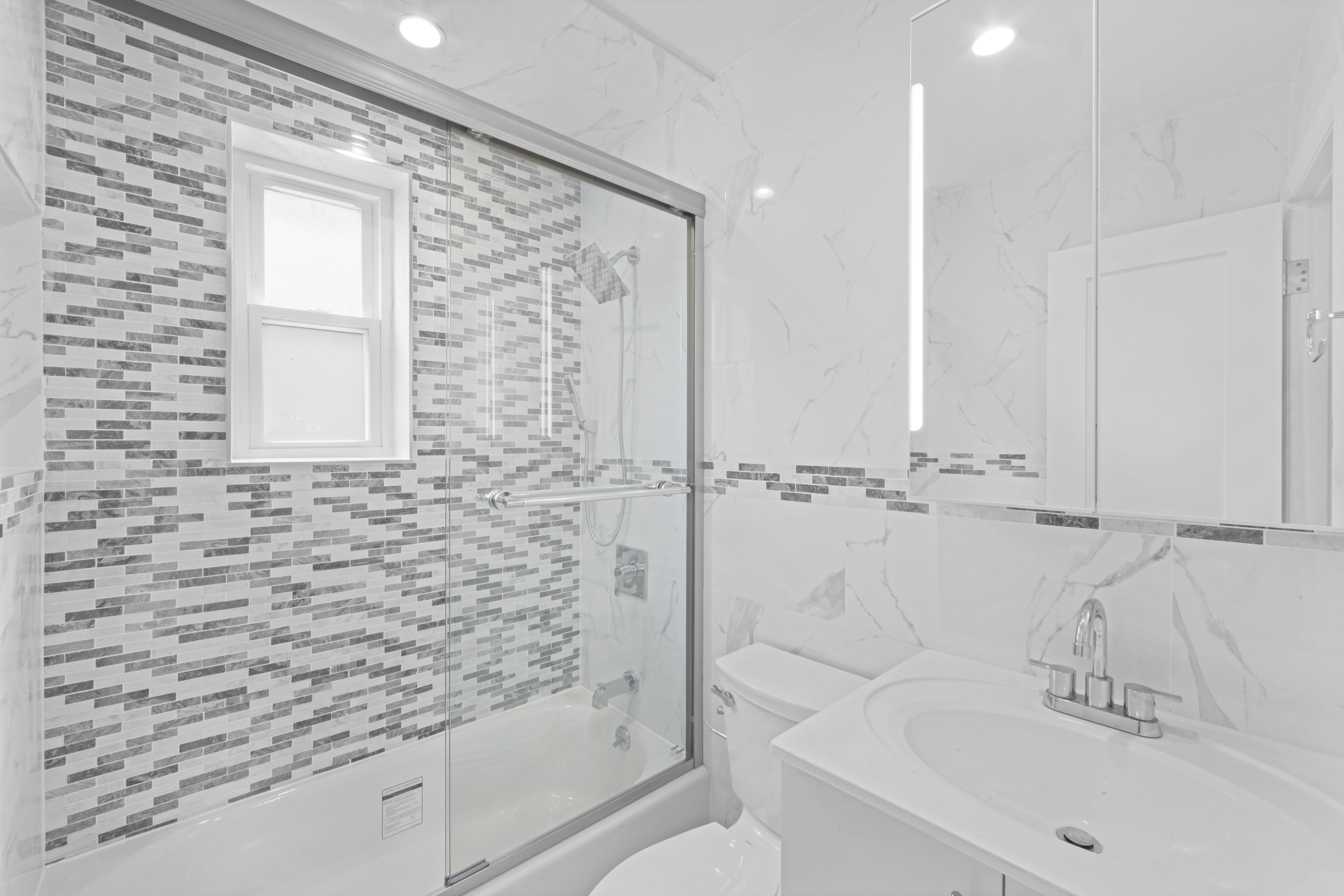2345 East 1st Street, Unit 2 Brooklyn, NY 11223 - Photo 7 of 10 a bathroom with a sink and a bathtub