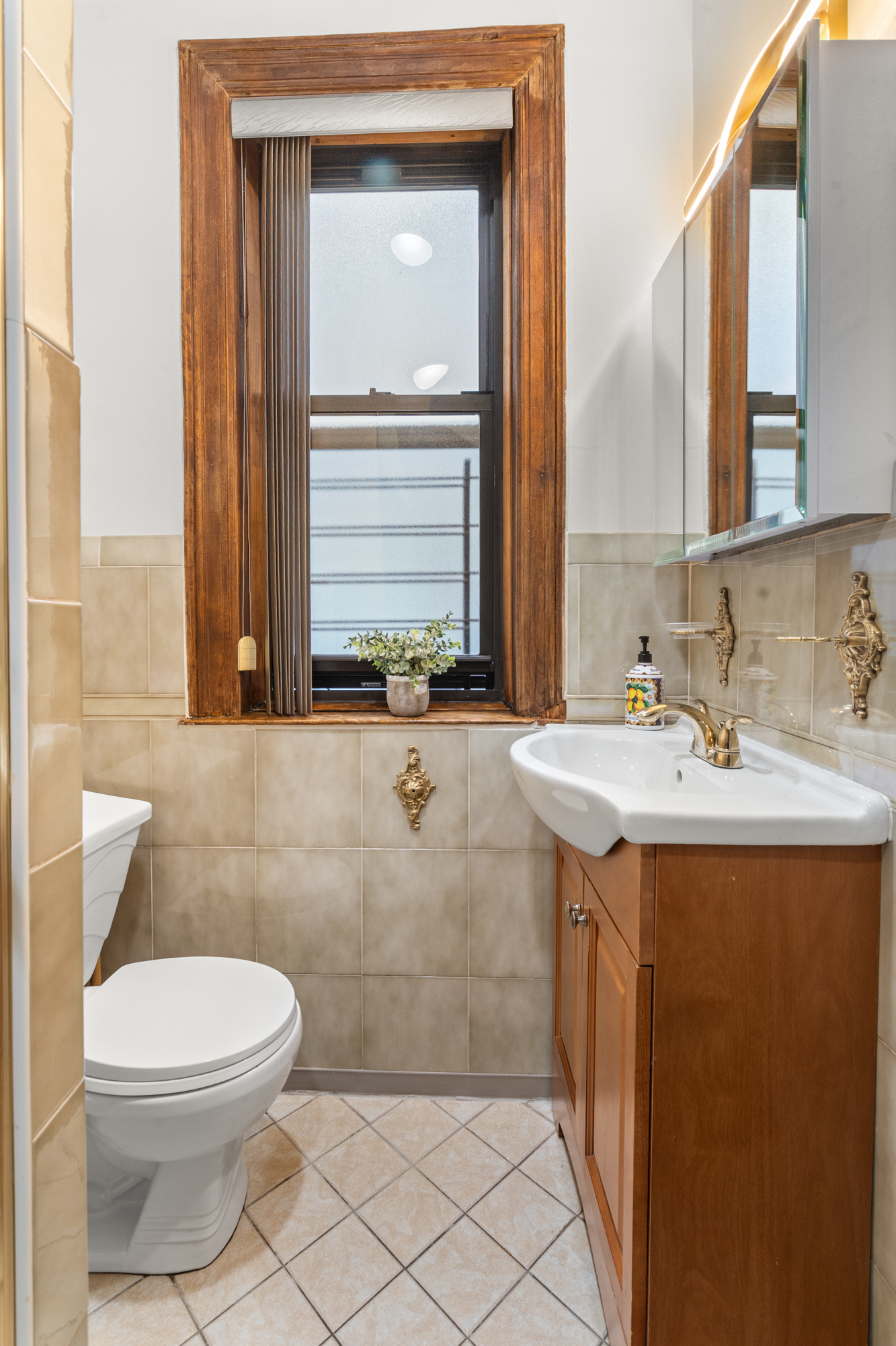 527 West 143rd Street, Unit 31 Manhattan, NY 10031 - Photo 18 of 29 a bathroom with a sink a toilet and mirror