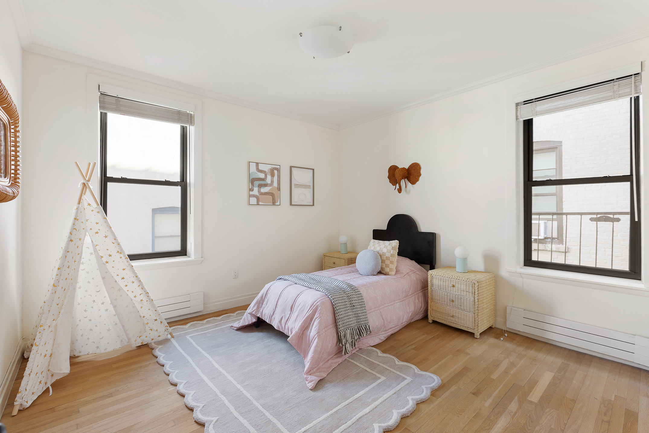 1845 Adam Clayton Powell Jr Boulevard, Unit 5C Manhattan, NY 10026 - Photo 12 of 17 a bedroom with a bed and a window