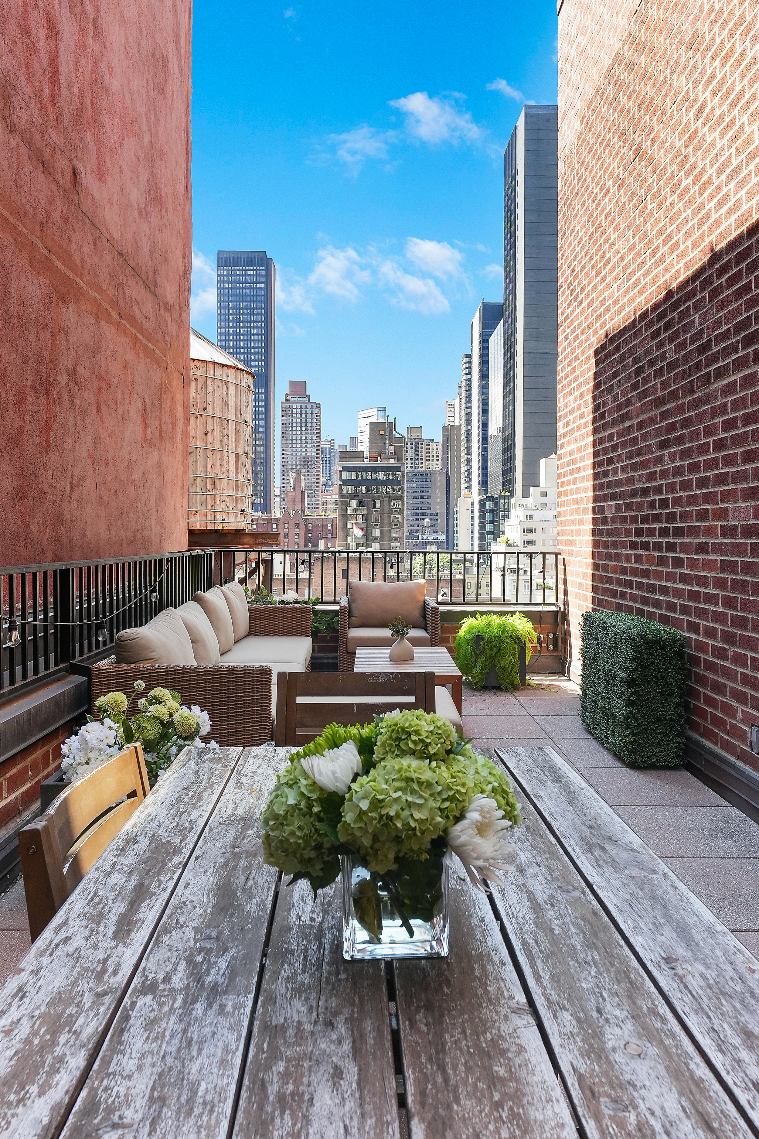 220 East 54th Street, Unit 11H Manhattan, NY 10022 - Photo 10 of 13 a view of a patio with couches table and chairs and potted plants