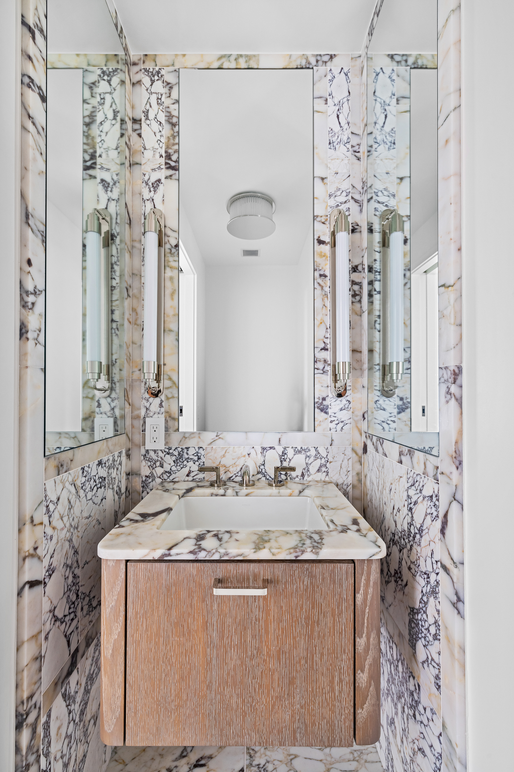 249 East 62nd Street, Unit 10B Manhattan, NY 10065 - Photo 4 of 21 a bathroom with a granite countertop sink a mirror and shower