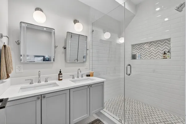 a bathroom with a sink a mirror and a shower