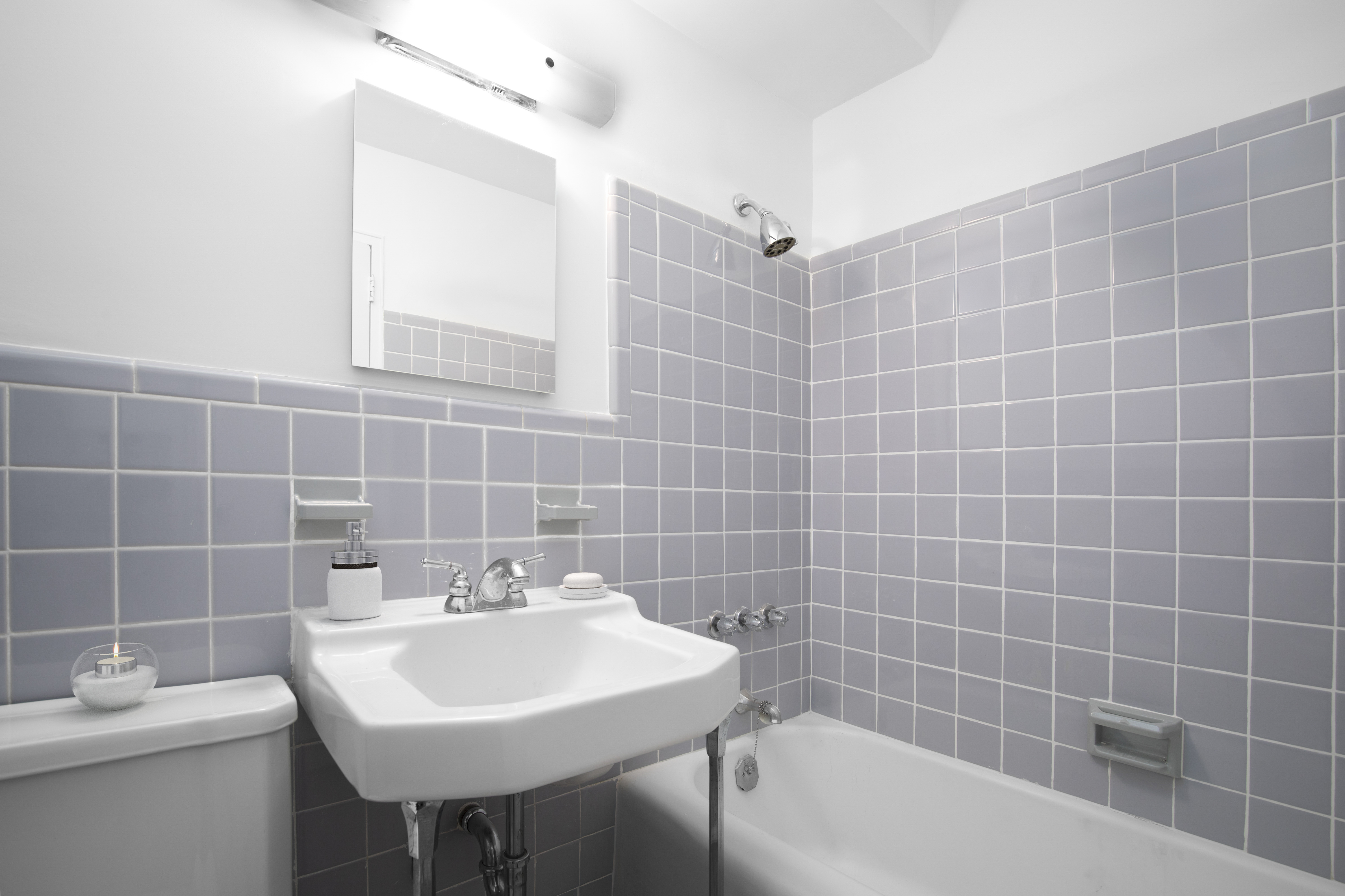 315 East 70th Street, Unit 7D Manhattan, NY 10021 - Photo 7 of 16 a bathroom with a sink a toilet a mirror and bathtub