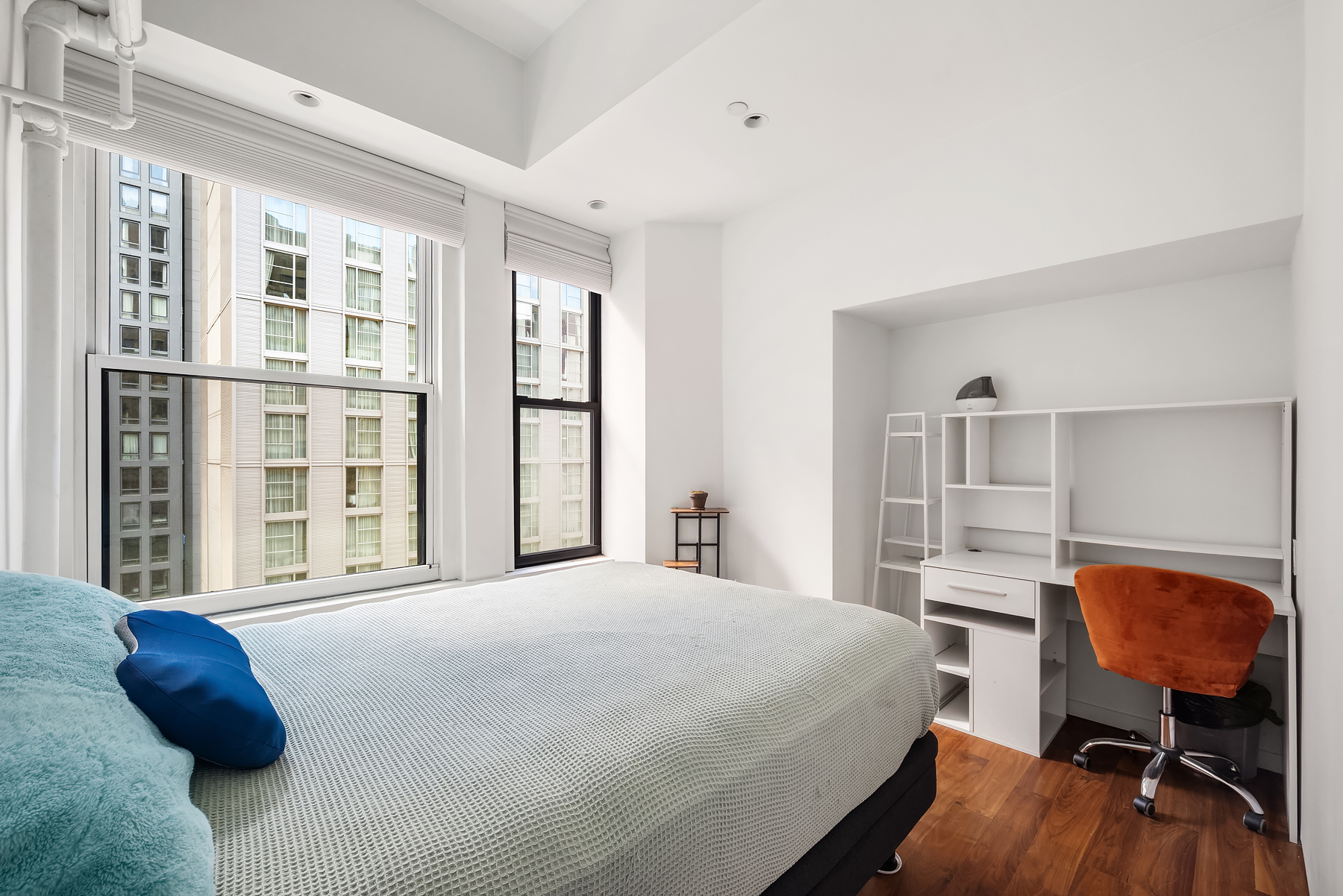 315 West 36th Street, Unit 11D Manhattan, NY 10018 - Photo 5 of 10 a bedroom with a bed and window