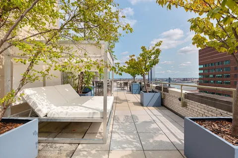 a terrace with outdoor seating and city view