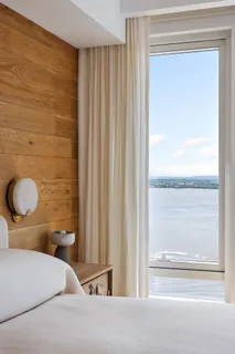 a bathroom with a double vanity sink a mirror and a bathtub