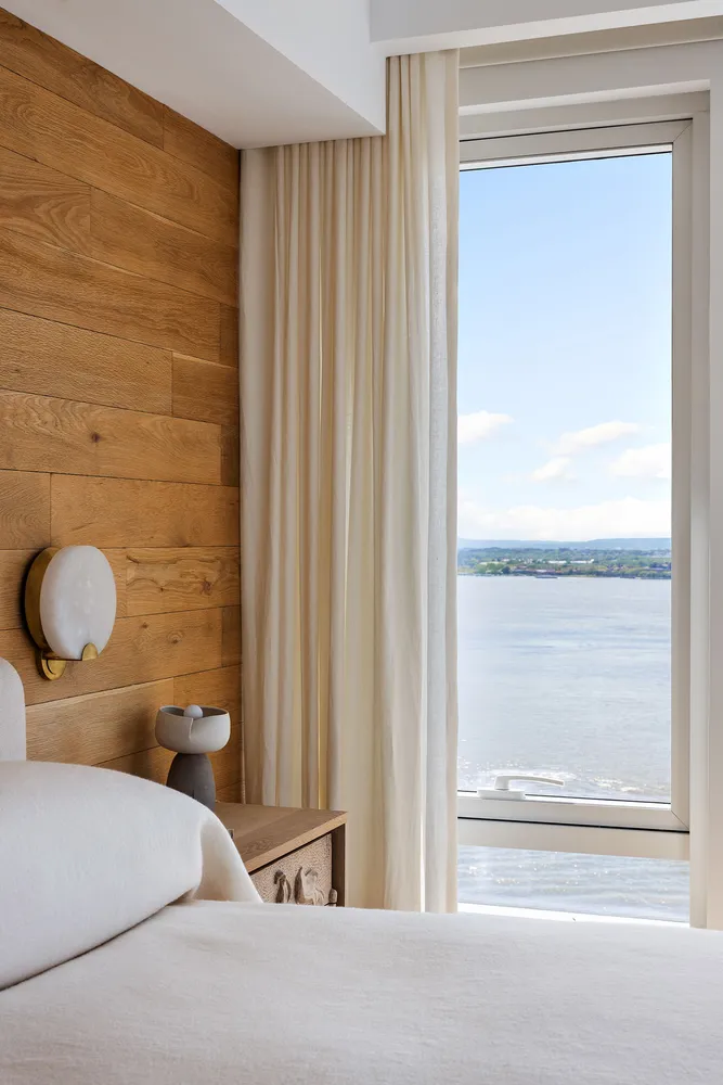 a bathroom with a double vanity sink a mirror and a bathtub
