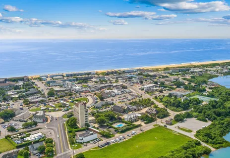 an aerial view of residential building and ocean