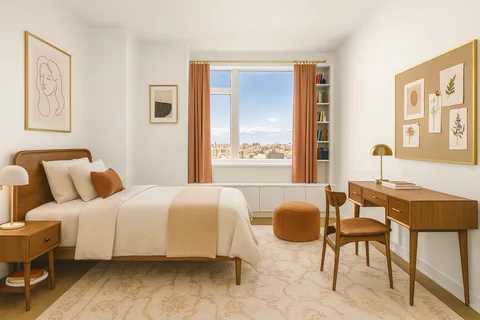 a bedroom with a bed and a dresser next to a window