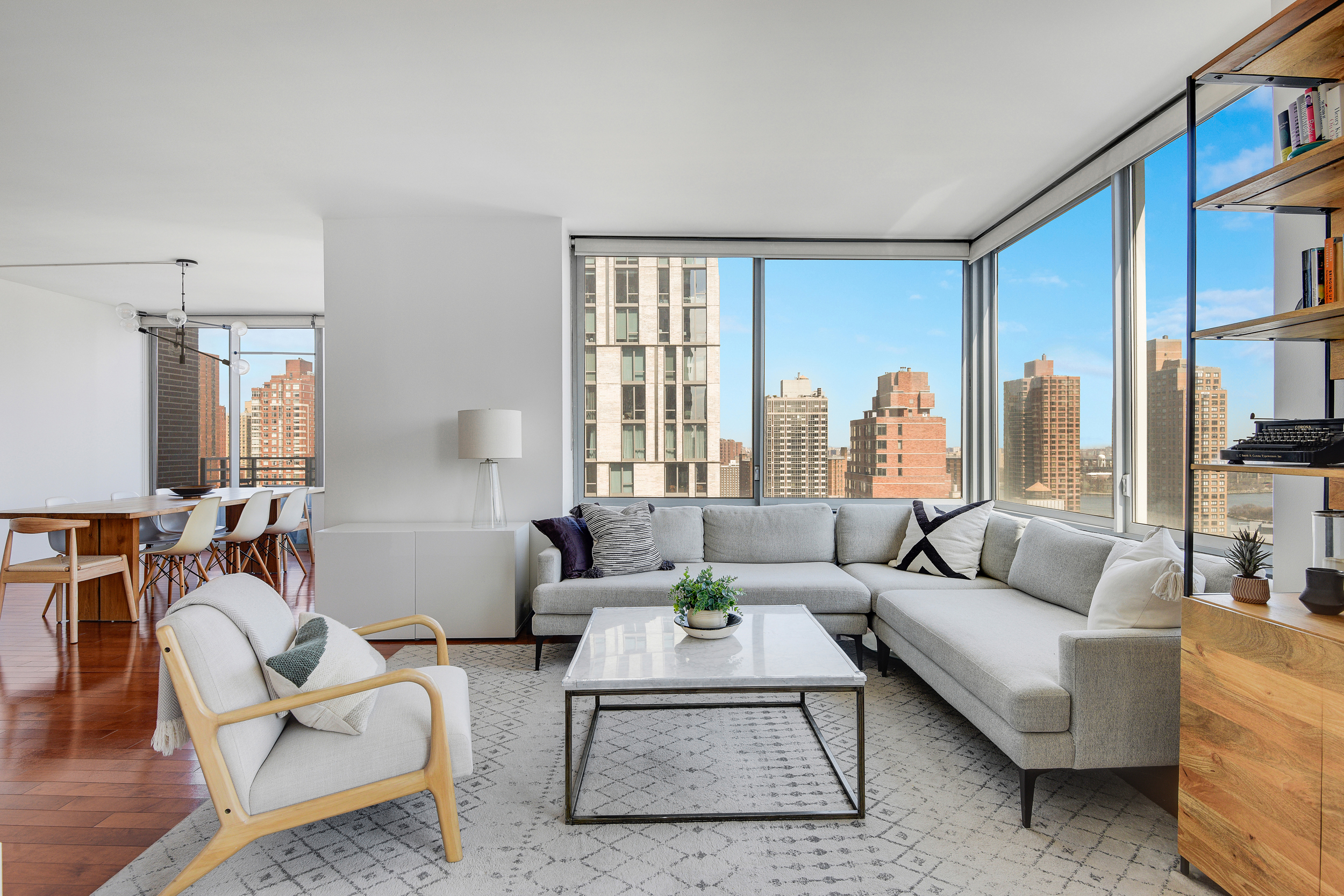360 East 88th Street, Unit 22C Manhattan, NY 10128 - Photo 3 of 33 a living room with furniture and a large window