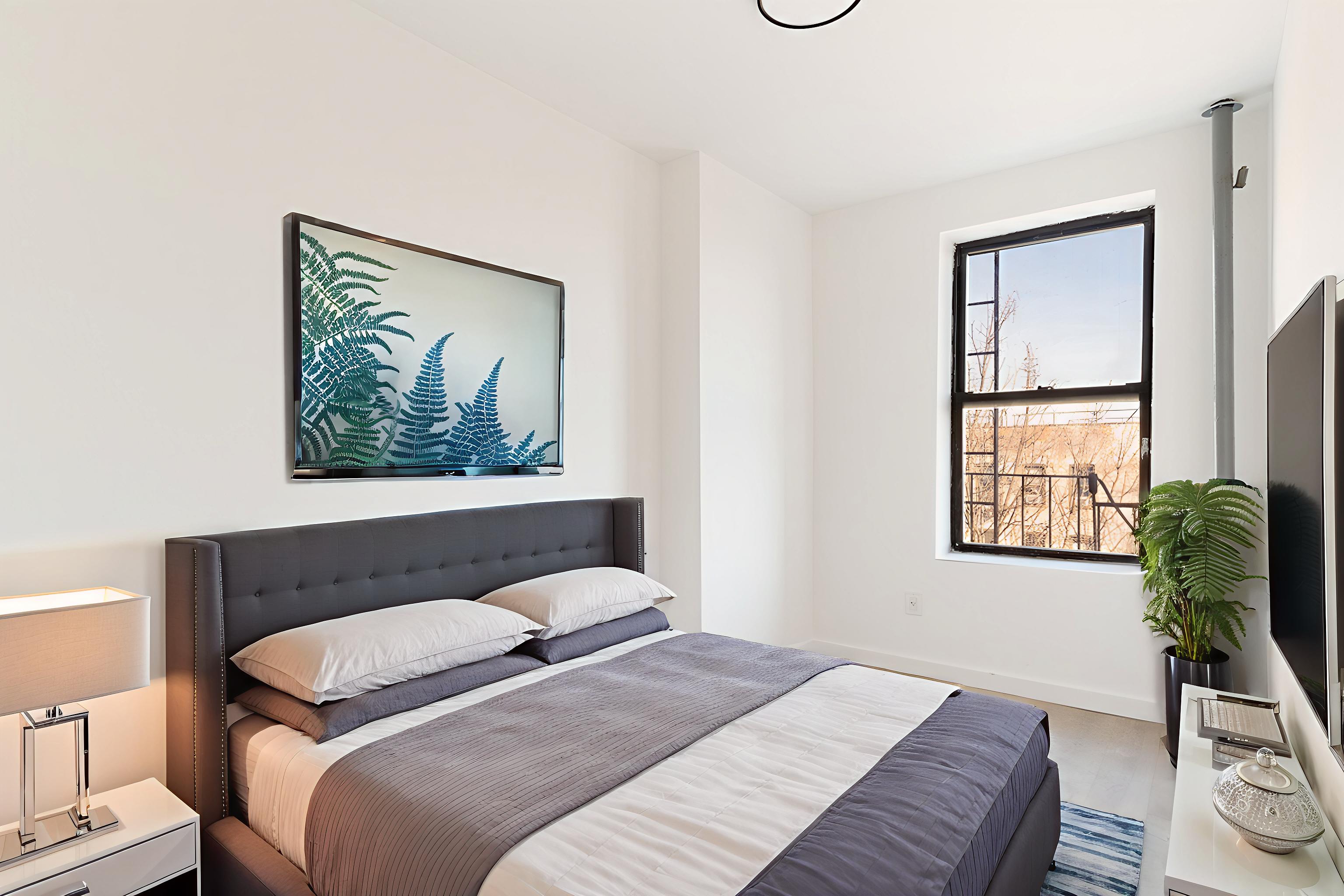 625 Park Place, Unit 3A Brooklyn, NY 11238 - Photo 3 of 9 a bedroom with a bed and a painting on the wall