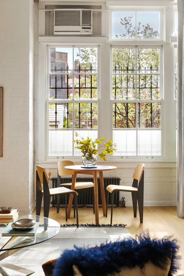 a view of a dining room with furniture and window