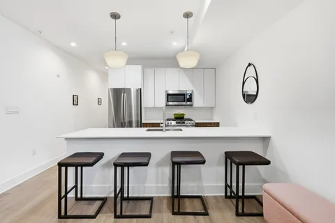 a kitchen with cabinets and chandelier