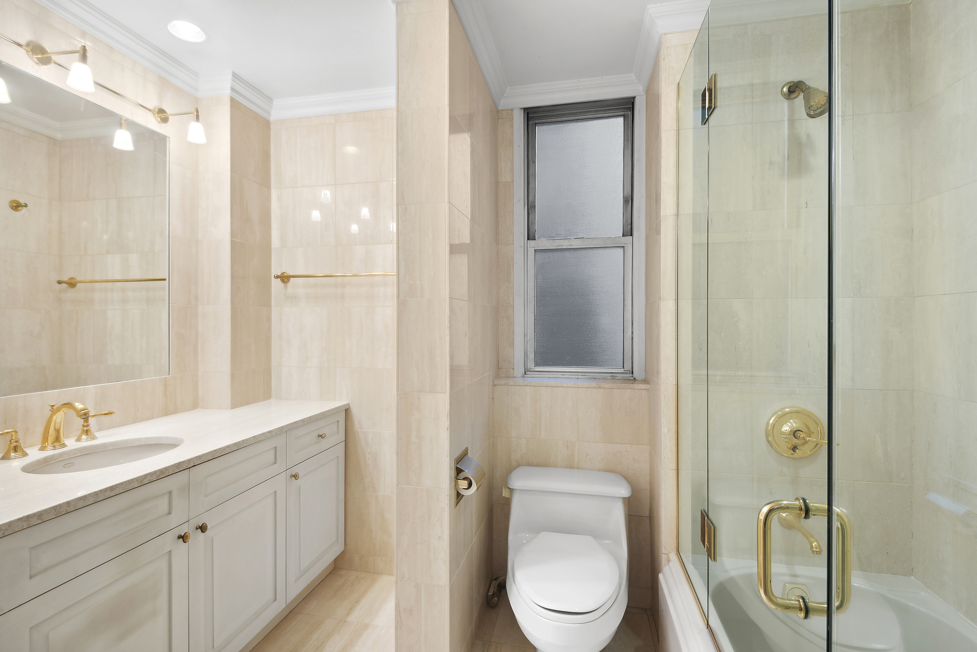 145 West 86th Street, Unit 12B Manhattan, NY 10024 - Photo 10 of 12 a bathroom with a toilet a sink and shower