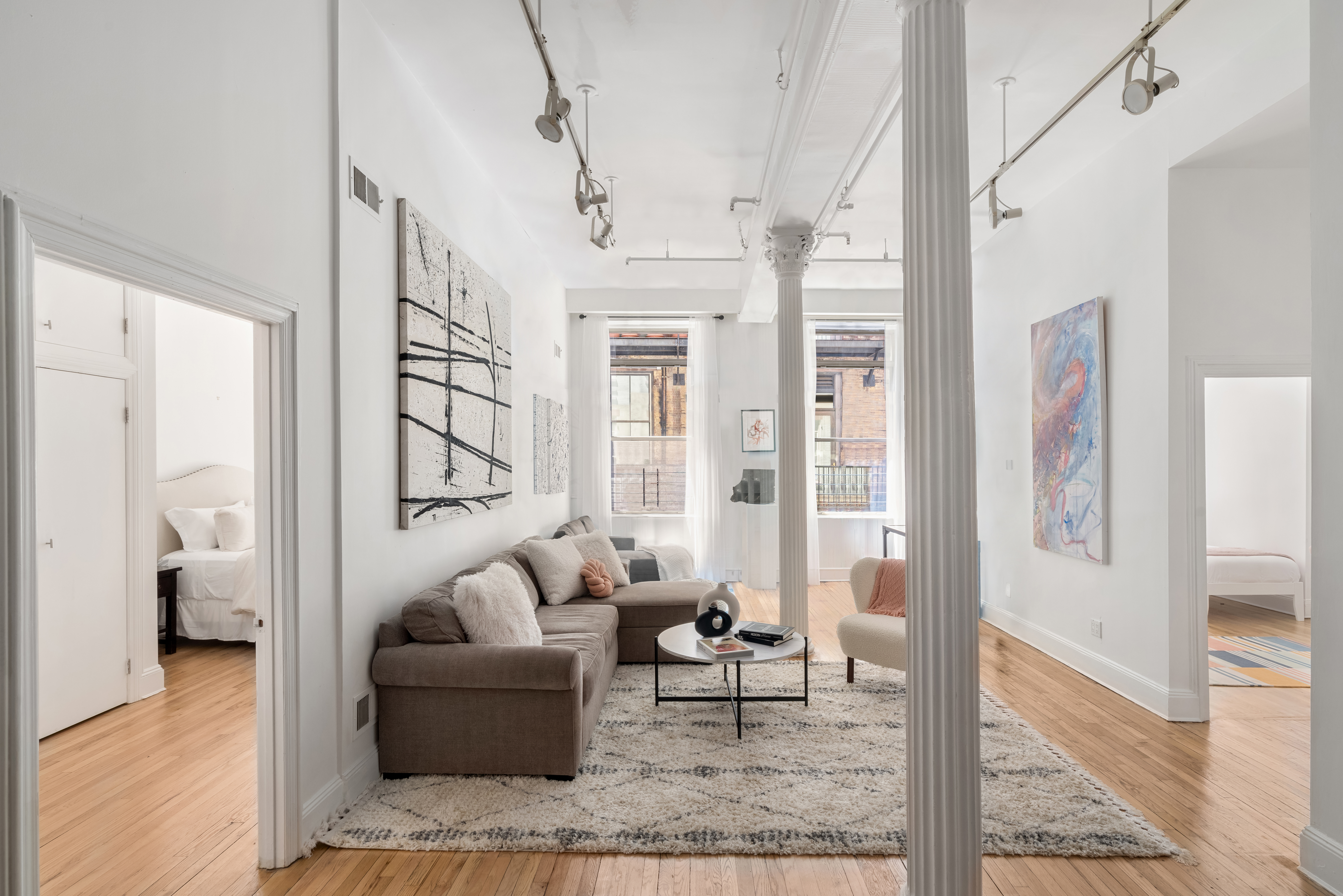 80 Leonard Street, Unit 3G Manhattan, NY 10013 - Photo 2 of 30 a living room with furniture and a glass door shower
