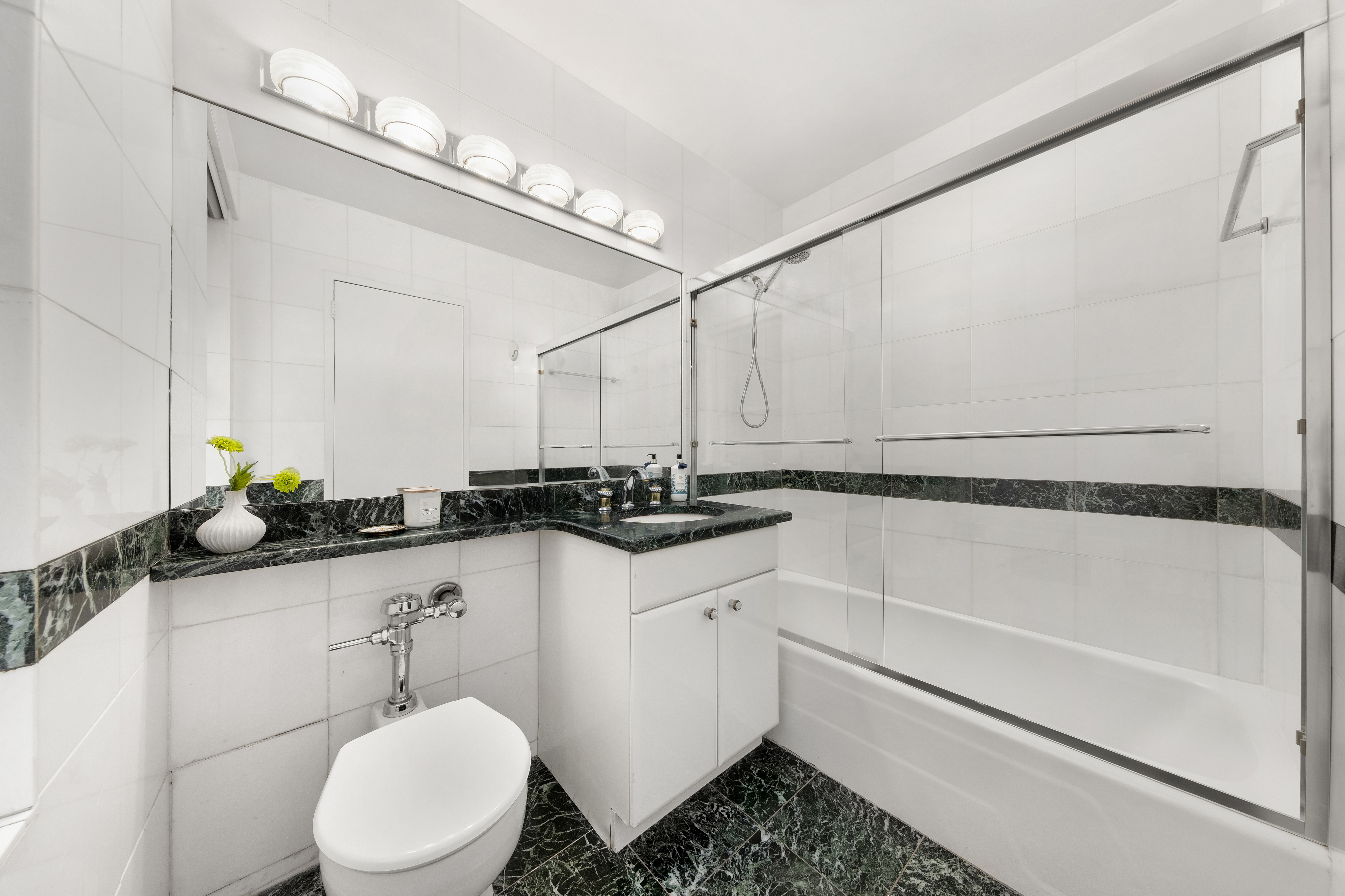 530 East 72nd Street, Unit 4F Manhattan, NY 10021 - Photo 11 of 23 a bathroom with a sink a toilet and a mirror