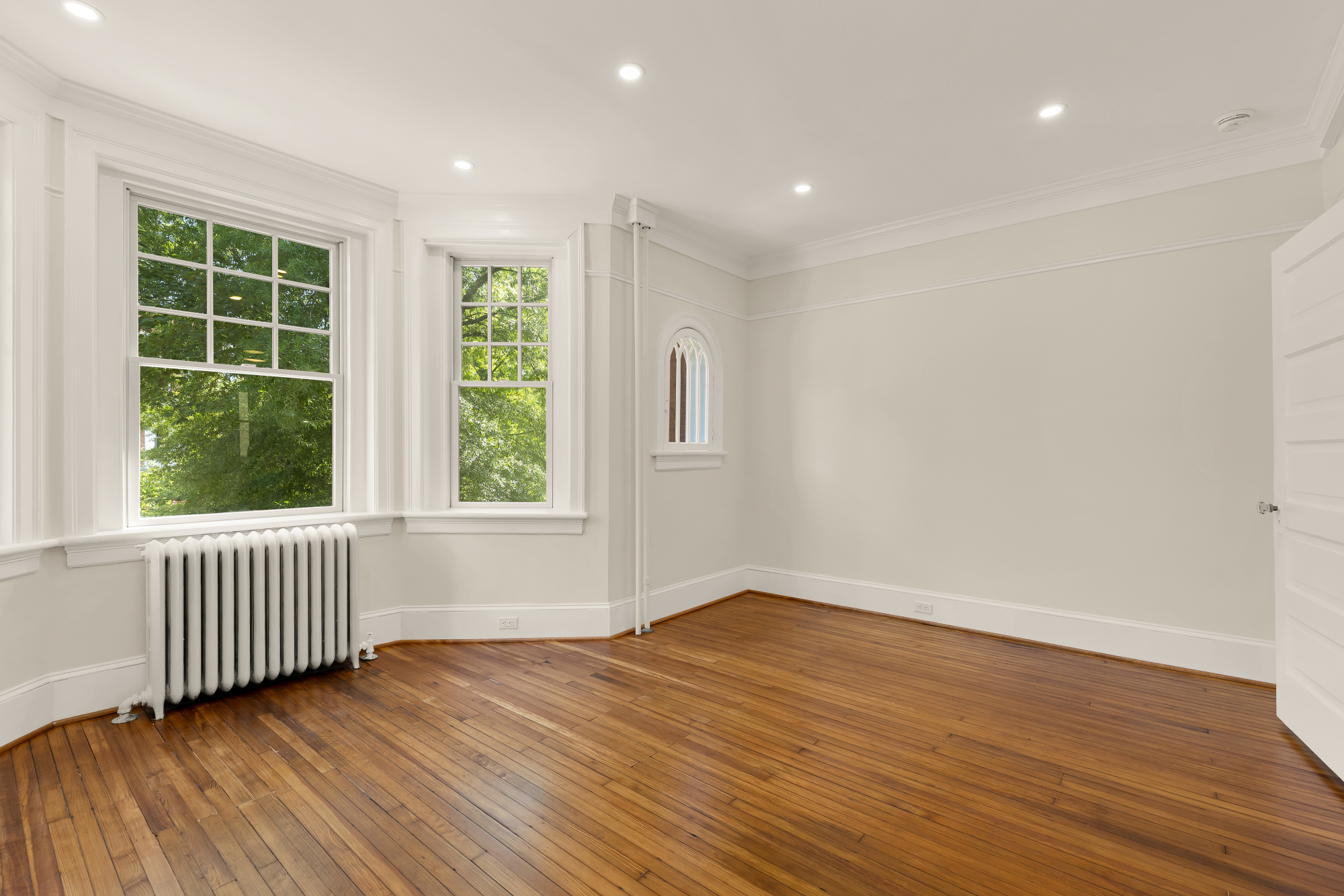 1737 Park Road Northwest Washington, DC 20010 - Photo 26 of 32 a view of an empty room with wooden floor and a window