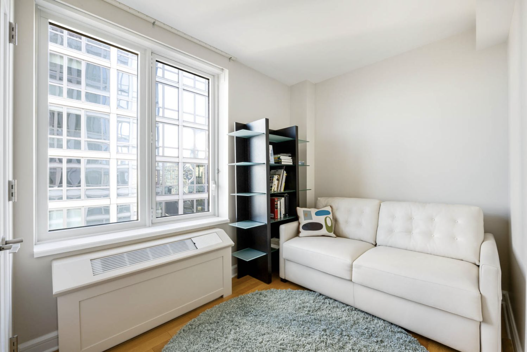 80 Riverside Boulevard, Unit 23C Manhattan, NY 10069 - Photo 12 of 19 a living room with furniture and a window