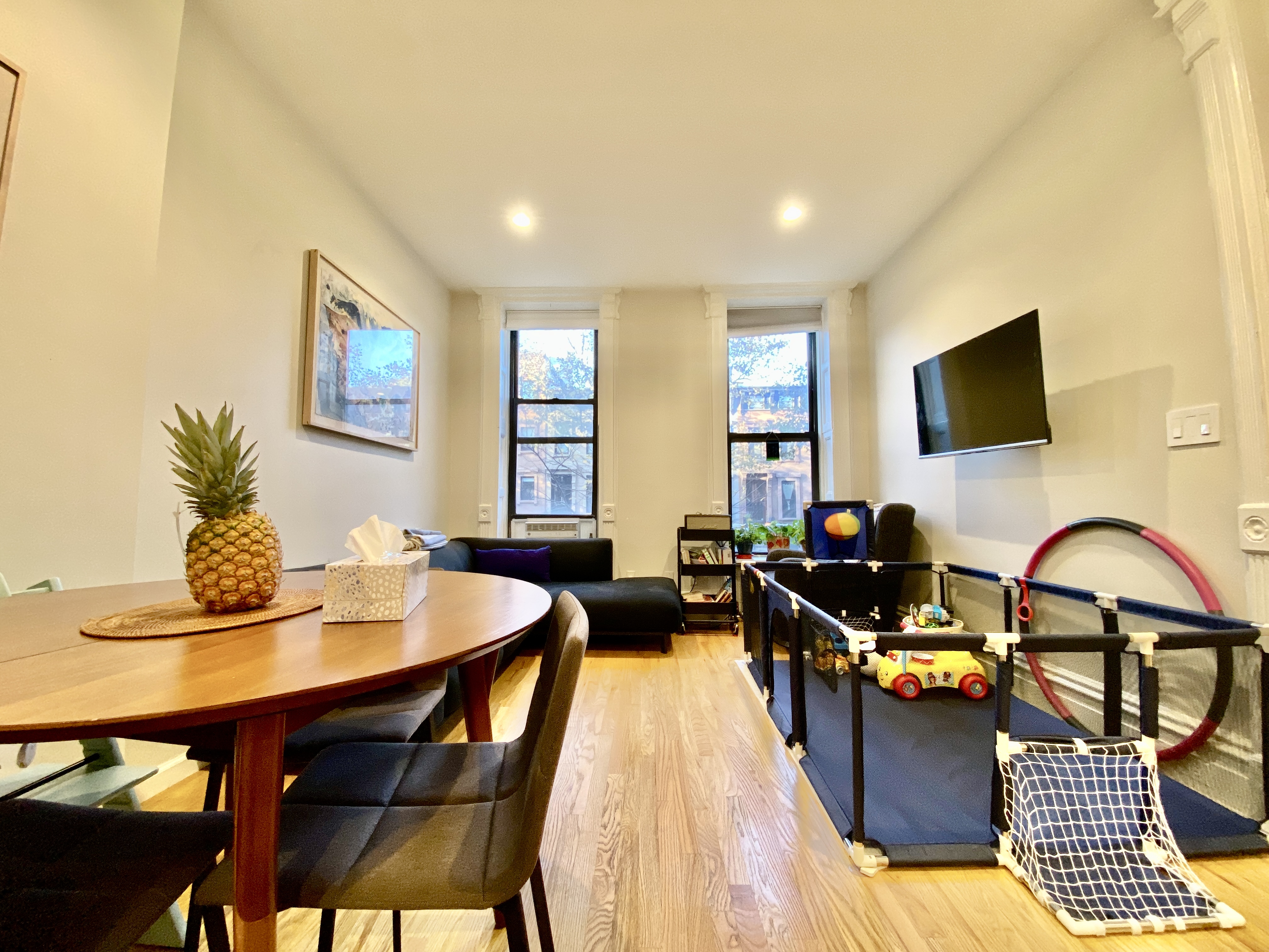 602 Madison Street, Unit 2 Brooklyn, NY 11221 - Photo 1 of 10 a living room with furniture a flat screen tv and a large window