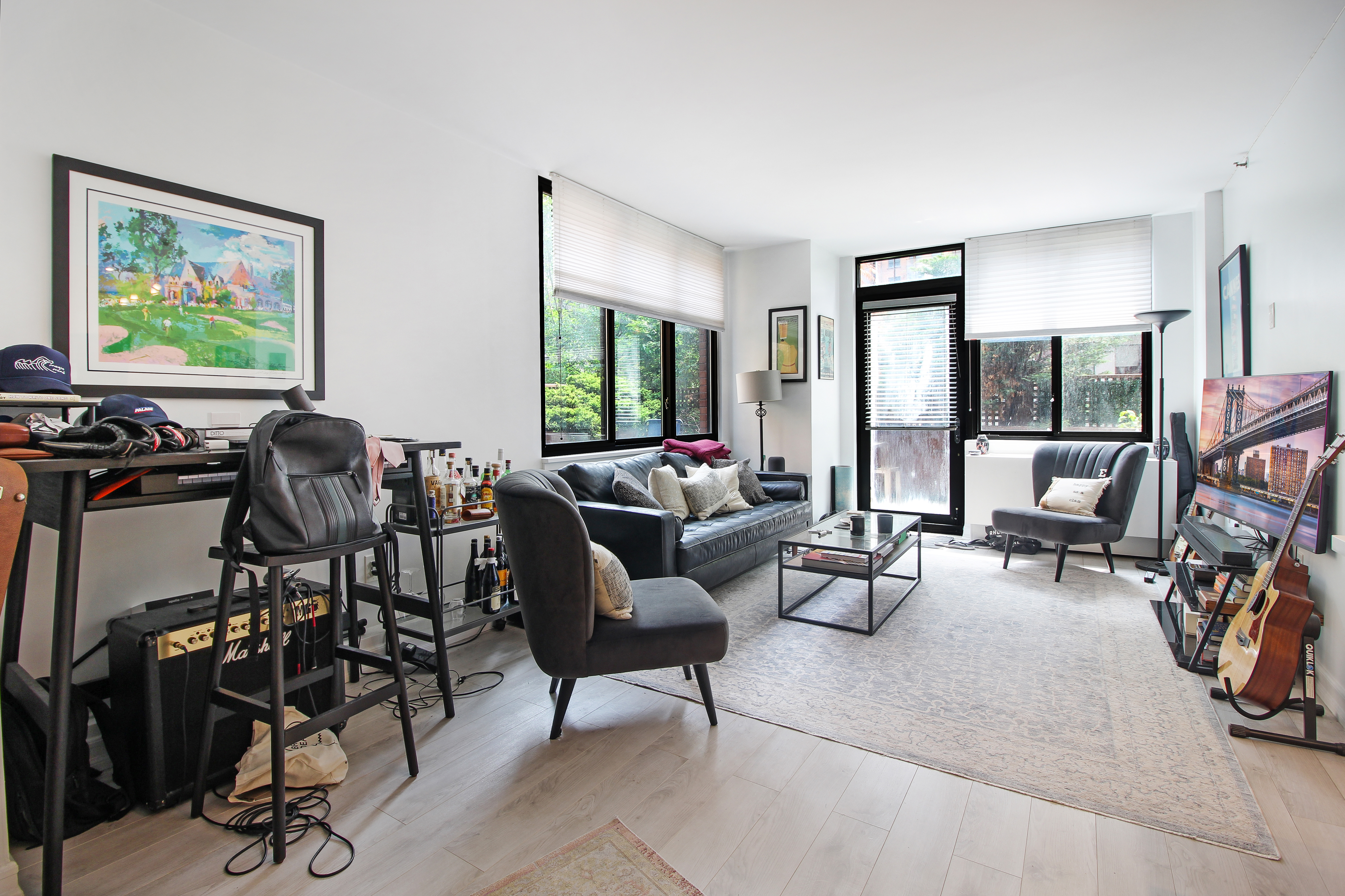 199 Bowery, Unit 2B Manhattan, NY 10002 - Photo 1 of 12 a living room with furniture a flat screen tv and a large window