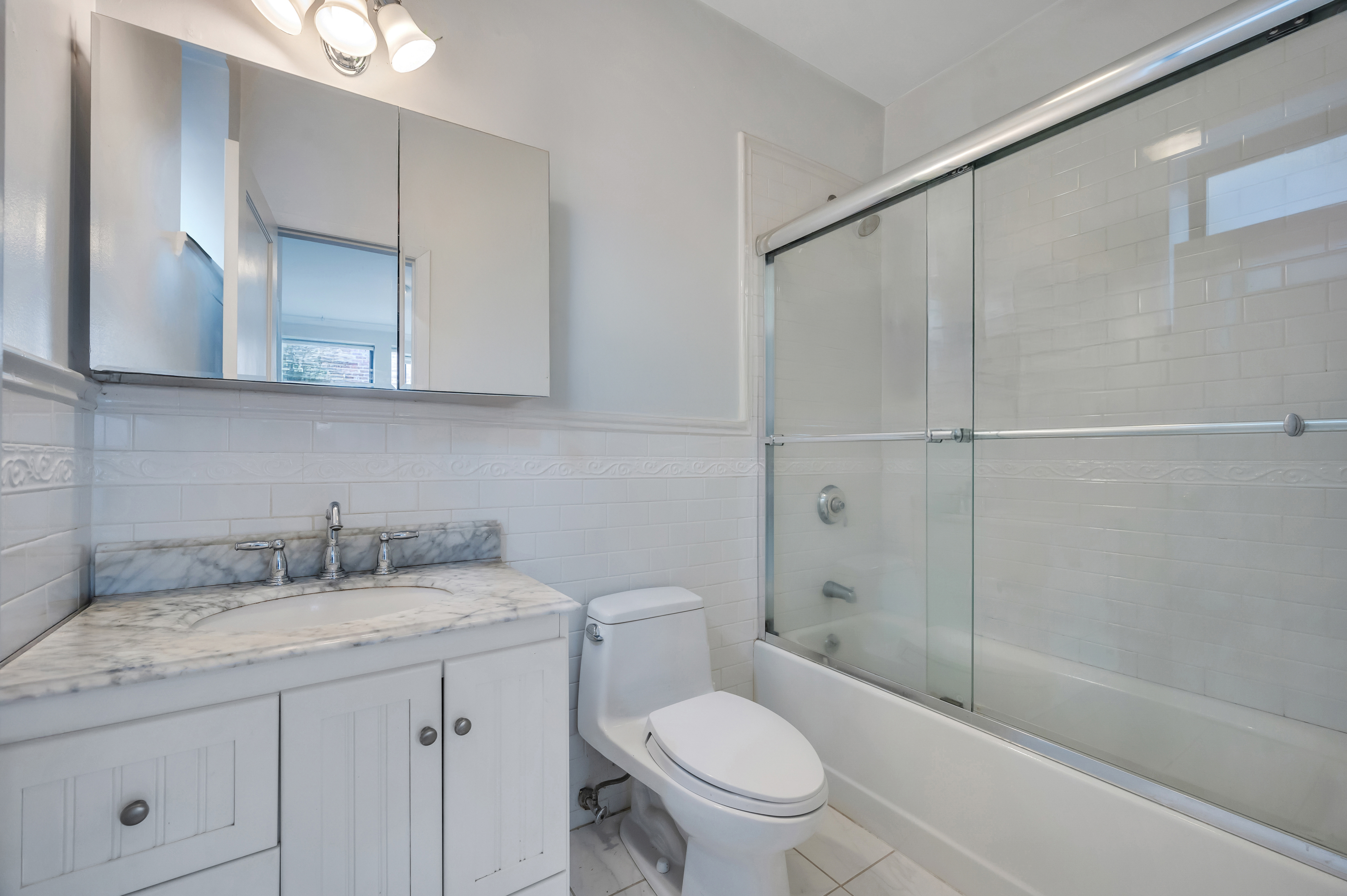 120 2nd Avenue, Unit 5A Manhattan, NY 10003 - Photo 8 of 13 a bathroom with a granite countertop sink a toilet and shower