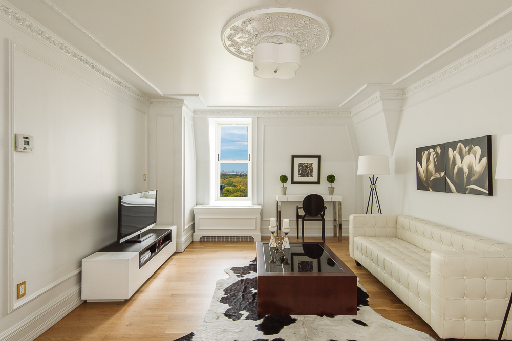 1 Central Park South, Unit 1801 Manhattan, NY 10019 - Photo 17 of 25 a living room with furniture and a flat screen tv