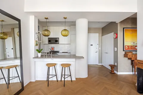 a living room with a sink and a table