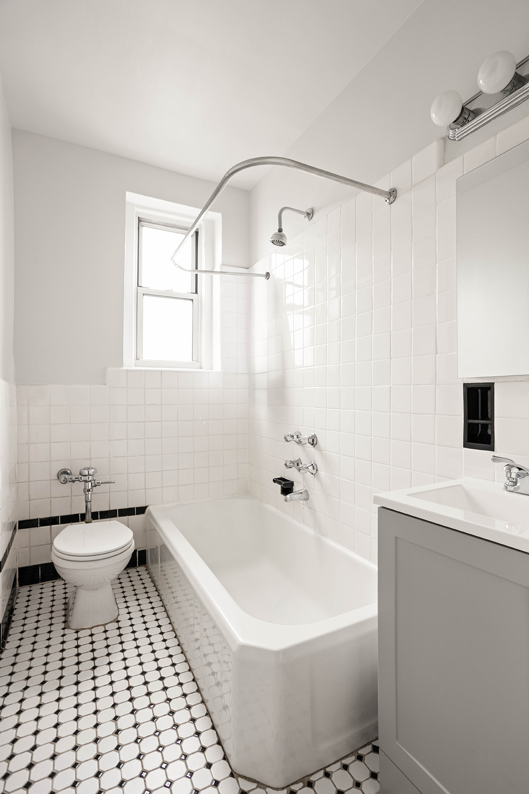 76-12 35th Avenue, Unit 6J Queens, NY 11372 - Photo 12 of 17 a bathroom with a bathtub and a toilet