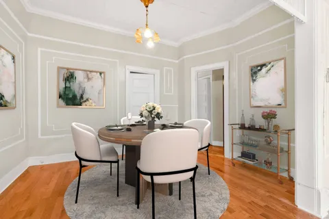 a view of an empty room and window with wooden floor