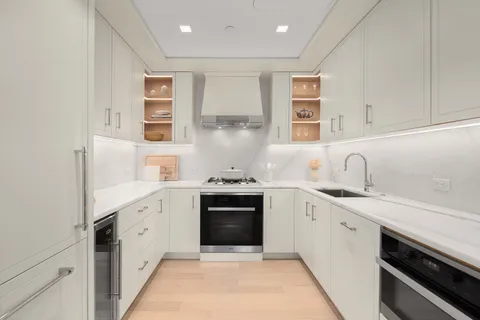a kitchen with a sink stove and cabinets