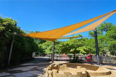 a view of yard with swimming pool and trees in the background