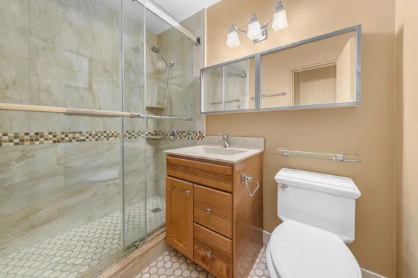 a bathroom with a toilet sink and mirror