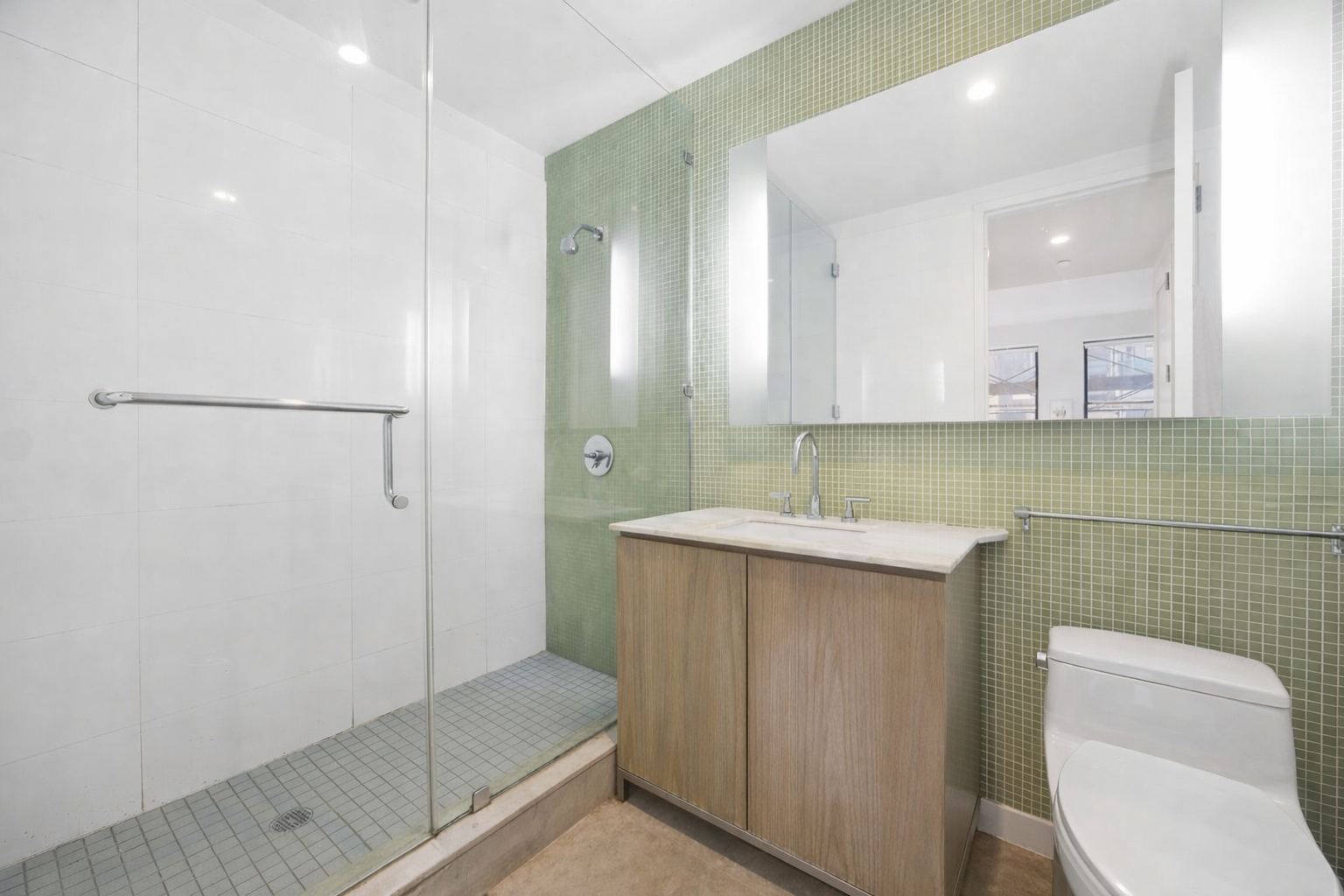 71 Nassau Street, Unit 13C Manhattan, NY 10038 - Photo 14 of 16 a bathroom with a sink a toilet and shower