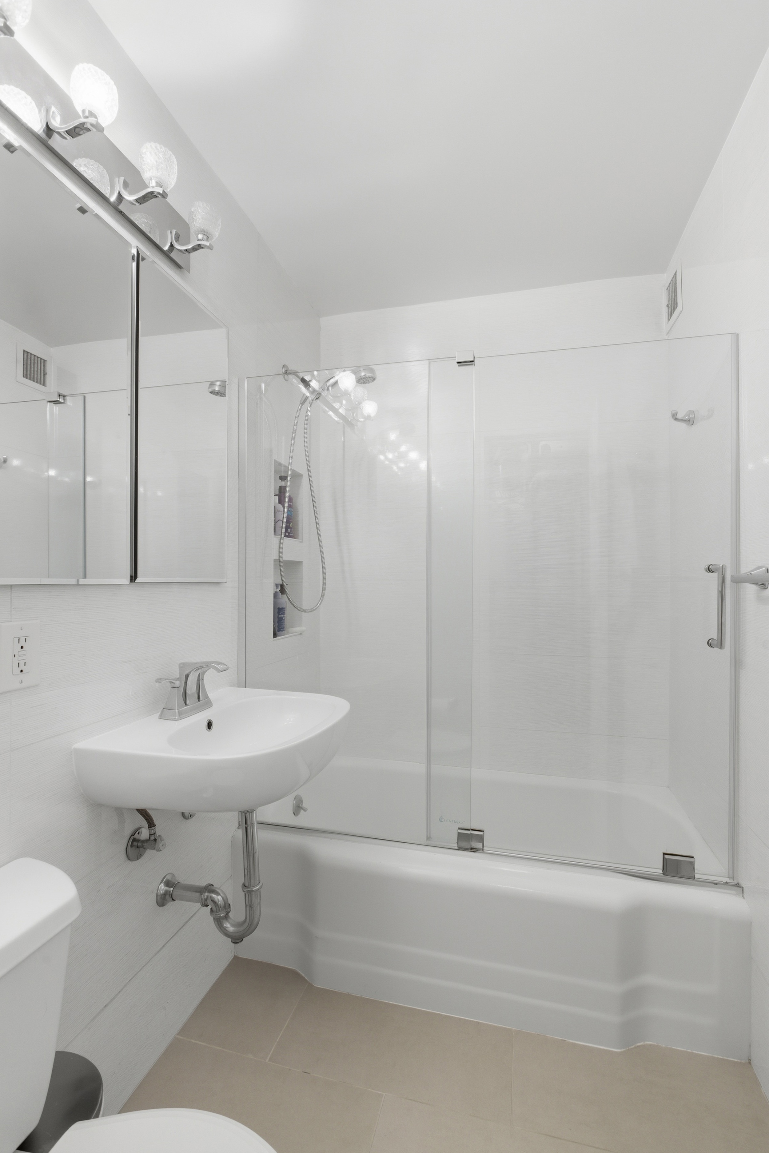 345 East 81st Street, Unit 12G Manhattan, NY 10028 - Photo 7 of 8 a bathroom with a sink a toilet and a bathtub