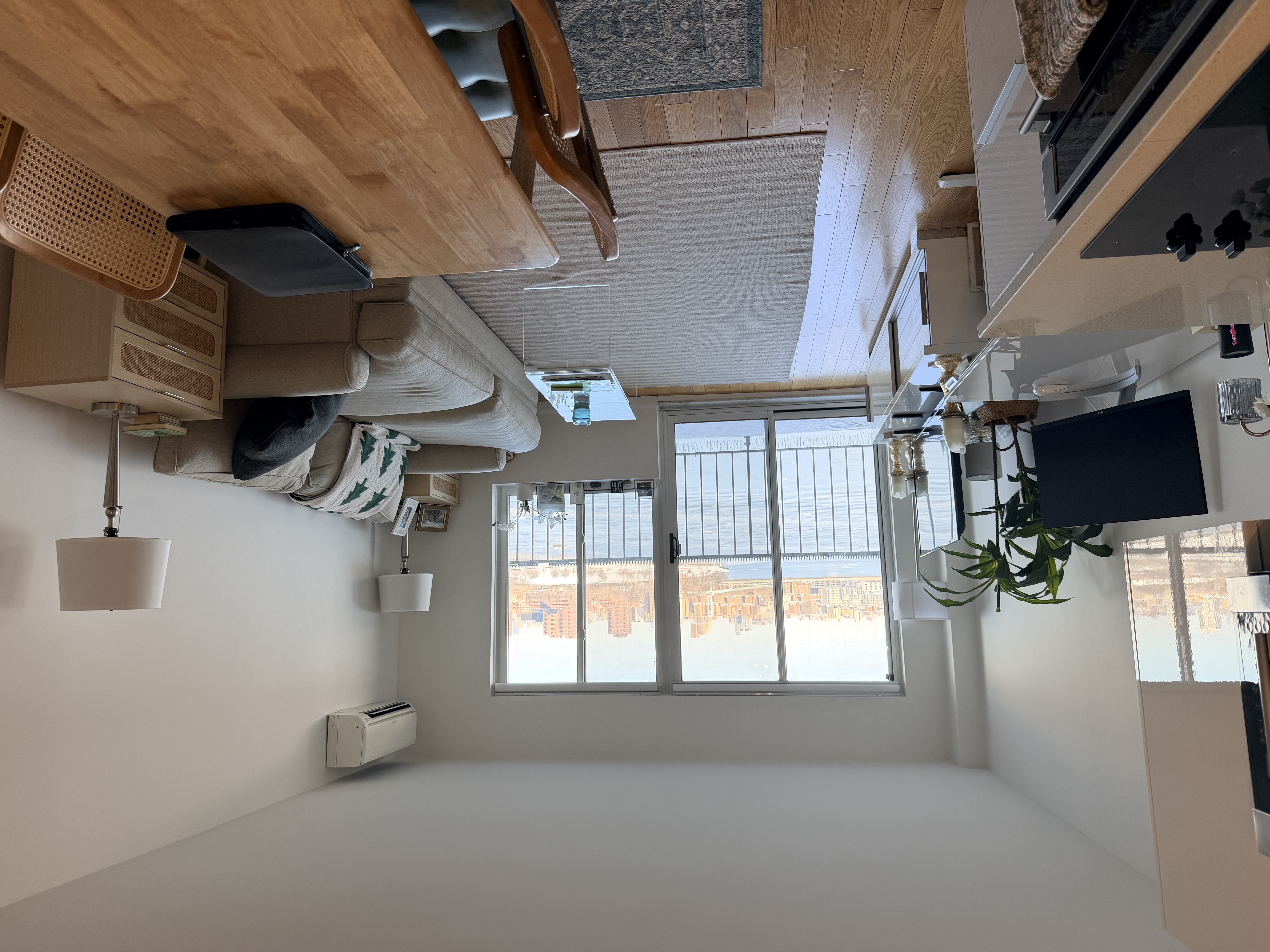 25-40 Shore Boulevard, Unit 15T Queens, NY 11102 - Photo 1 of 24 a living room with furniture and a flat screen tv