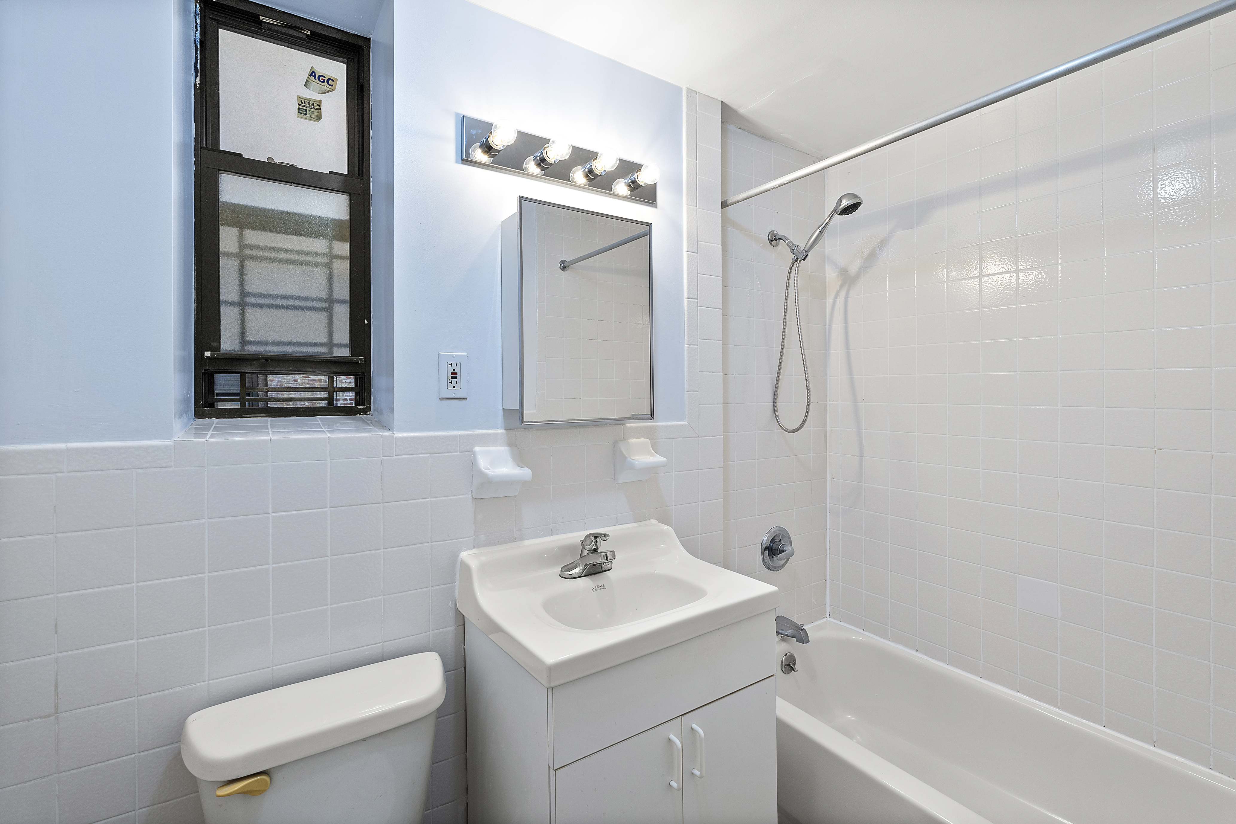 660 St Nicholas Avenue, Unit 33 Manhattan, NY 10030 - Photo 4 of 11 a bathroom with a sink a toilet and shower