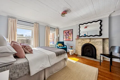 a bedroom with a bed and a fireplace