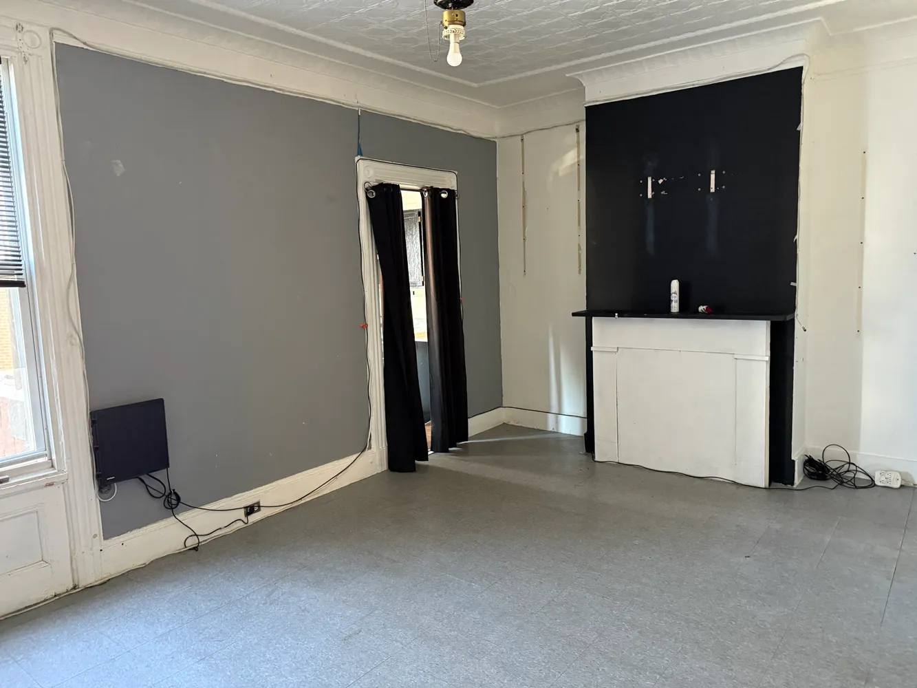 a view of a room with a flat tv screen and a ceiling fan