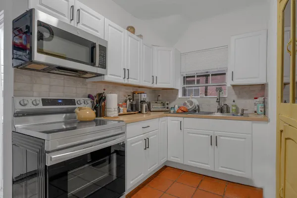 a front view of a multi story building with yard