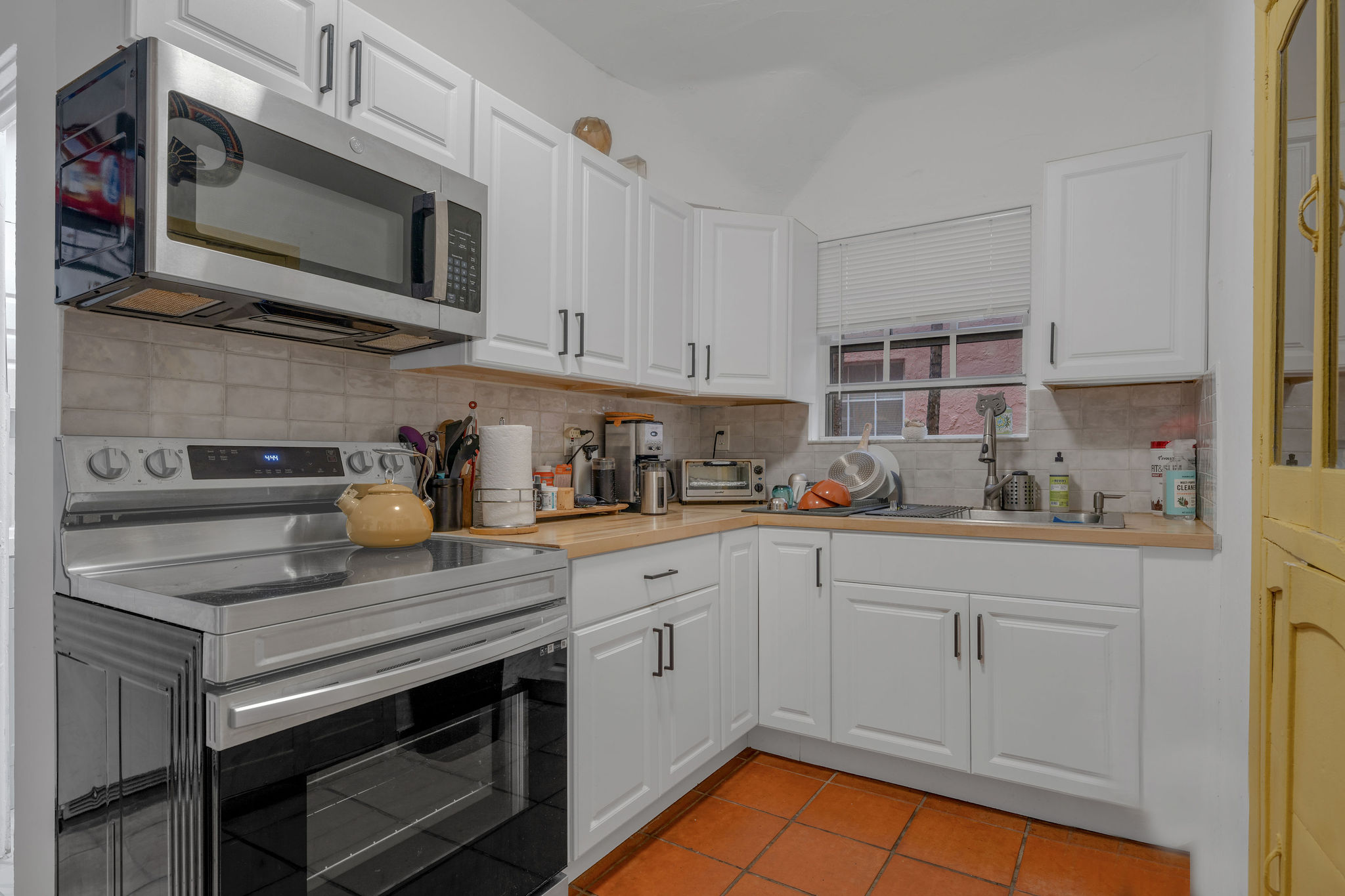735-745 Meridian Avenue Miami Beach, FL 33139 - Photo 46 of 62 a kitchen with stainless steel appliances granite countertop a sink a stove and microwave
