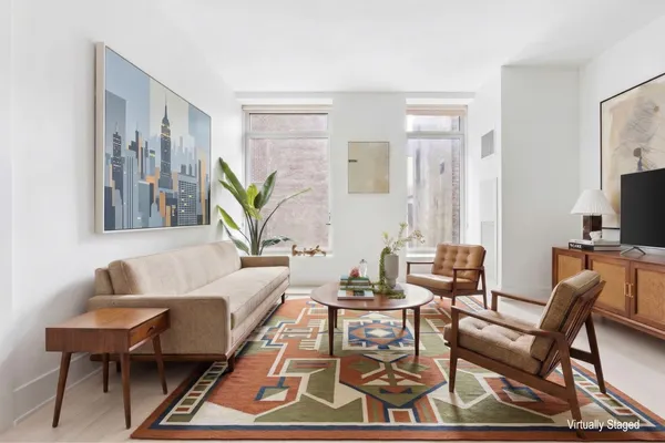 a living room with furniture a couch and a flat screen tv
