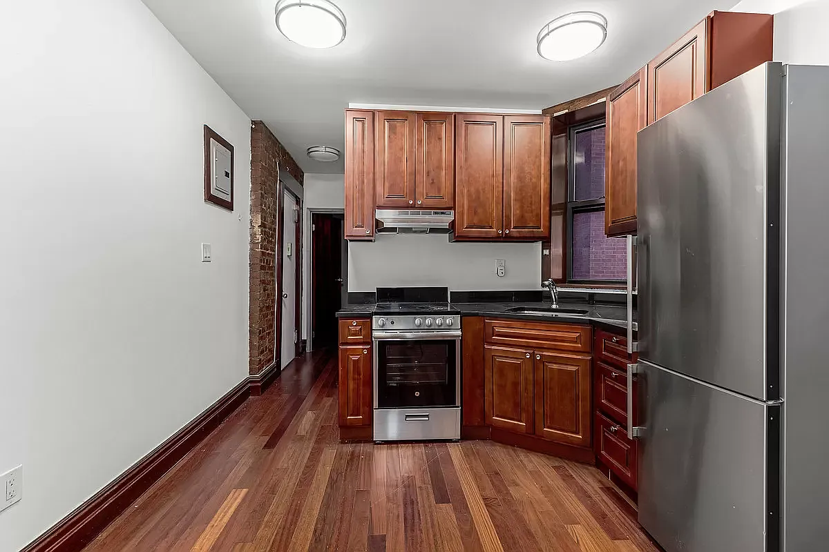 1392 Madison Avenue, Unit 11 Manhattan, NY 10128 - Photo 2 of 4 a kitchen with stainless steel appliances a refrigerator and a stove top oven