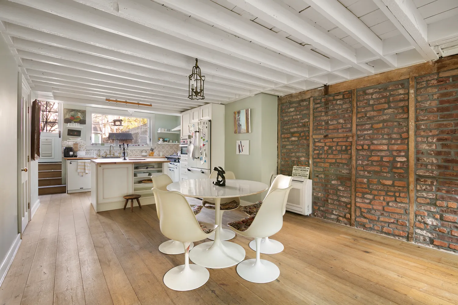 a dining room with furniture and wooden floor